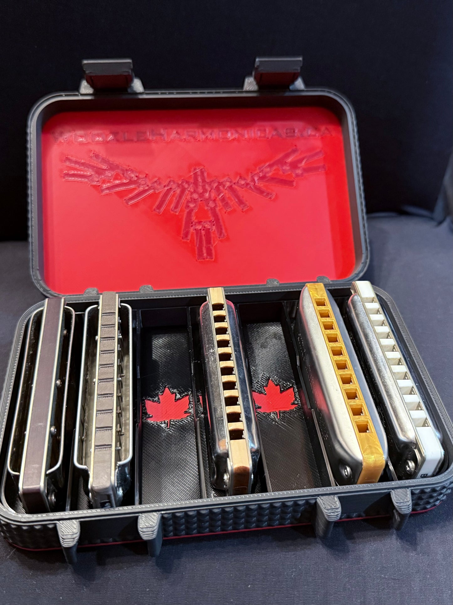 Open harmonica case showing five diatonic harmonicas stored in custom maple-leaf slotted compartments, with room for two more!
